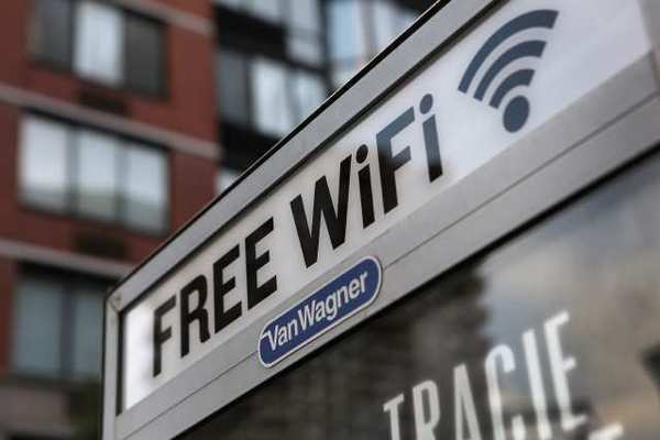 NEW YORK, NY - JULY 11: A free Wi-Fi hotspot beams broadband internet from atop a public phone booth on July 11, 2012 in Manhattan, New York City. New York City launched a pilot program Wednesday to provide free public Wi-Fi at public phone booths around the five boroughs. The first ten booths were lit up with Wi-Fi routers attached to the top of existing phone booths, with six booths in Manhattan, two in Brooklyn, and one in Queens. Additional locations, including ones in the Bronx and Staten Island, are to be added soon. (Photo by John Moore/Getty Images)